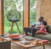 Two people looking at the modern bird cage