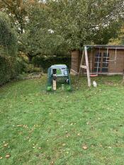 An Eglu Cube chicken coop in a garden