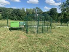 Green Eglu Cube large chicken coop with run connected to Omlet walk in chicken run in garden